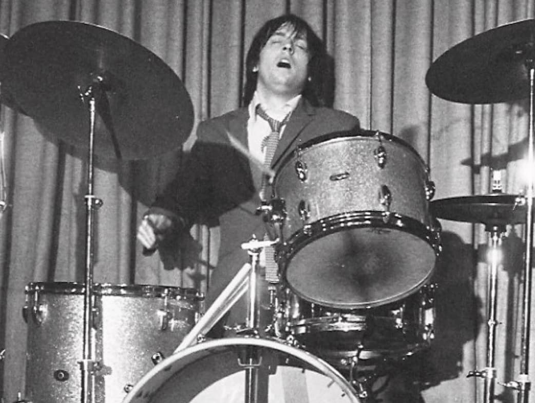 The Pleasers drummer performing