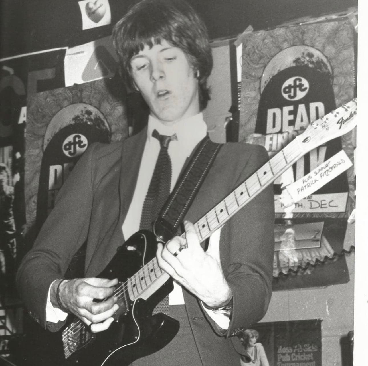 The Pleasers guitarist performing